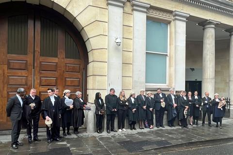 Criminal barristers from the Western Circuit line up outside Bristol Crown Court he walkout